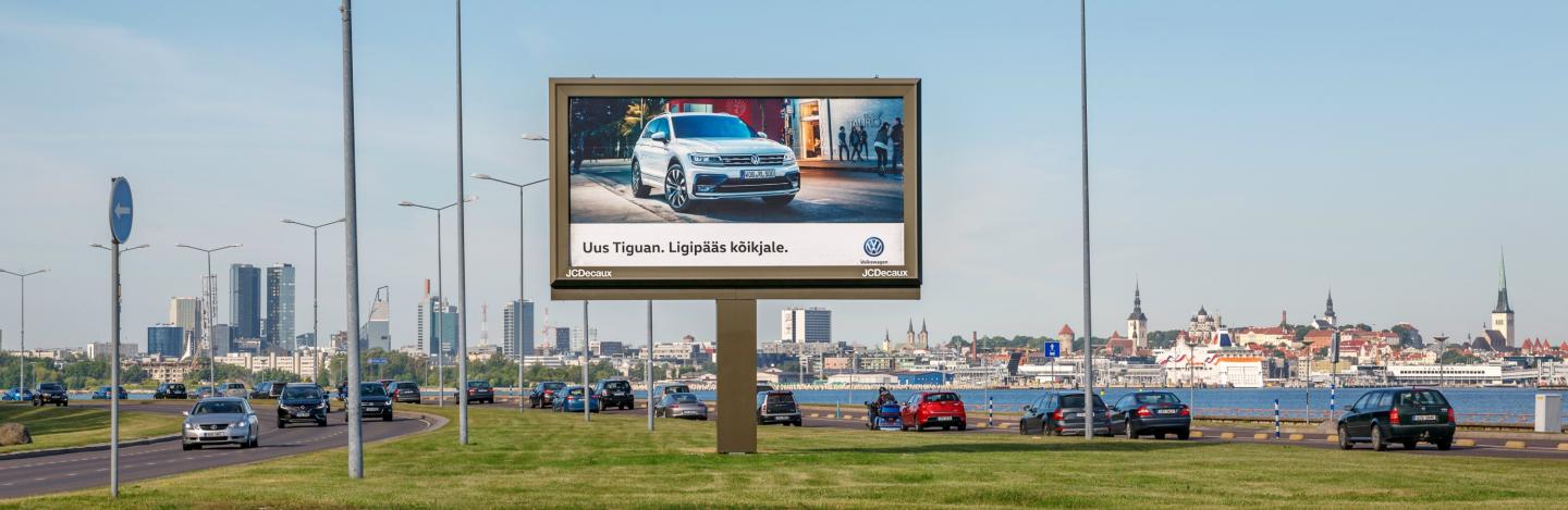 Large advertising billboard beside a busy urban road